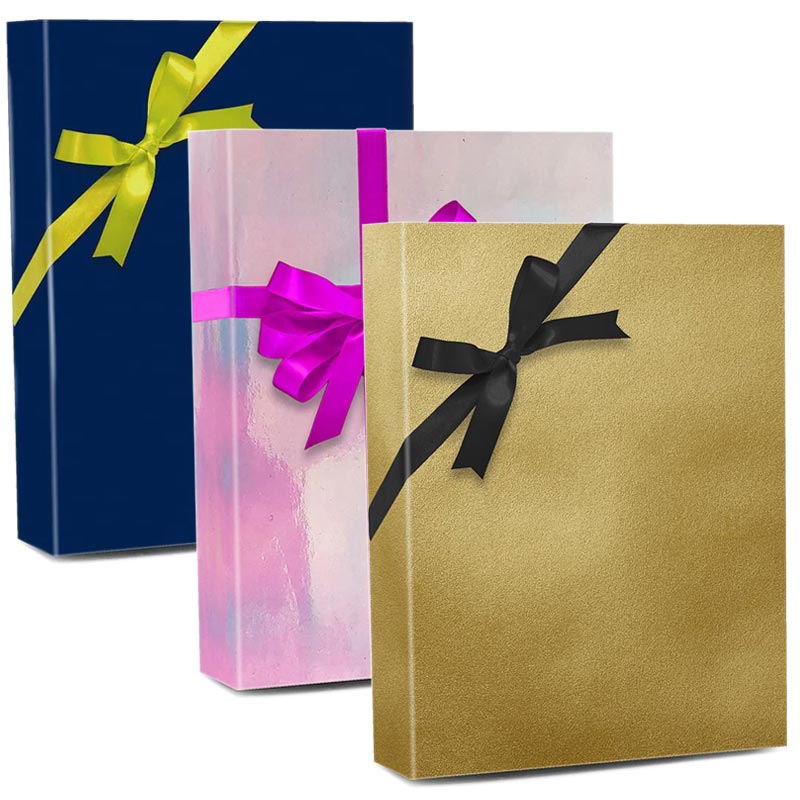 Rolls of colored wrapping paper with scissors and gift on white